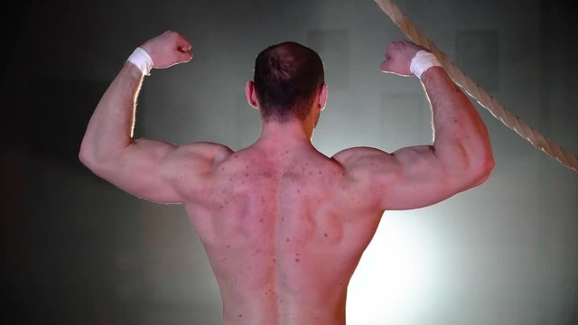 Bodybuilder shows back muscles