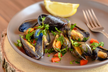 Plate of mussels with sauce and spices.