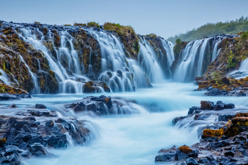 Obraz premium Dramatic views of the bright Bruarfoss waterfall. Popular tourist attraction. Location place South Iceland, Europe.