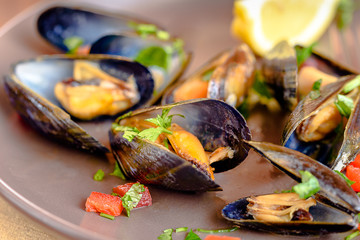 Plate of mussels with sauce and spices.