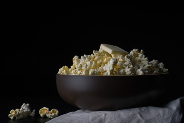 Buttered popcorn in a dark bowl