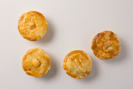 Stuffed chicken pie known as Empada in Portugal and Brazil. Snacks over white background, minimalism.