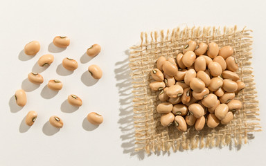 Cowpea legume.  Close up of grains spreaded over white table.