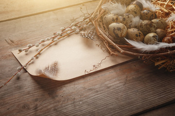 Colorful easter egg in nest on dark wood board.