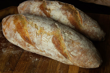 Fresh baked bread on wooden background
