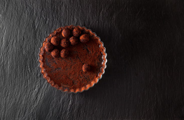 cooking Raw energy balls with dried fruit and nuts truffles in cocoa pouder