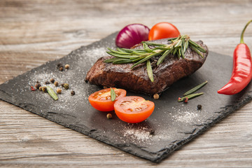 Delicious beef steak with rosemary and tomatoes