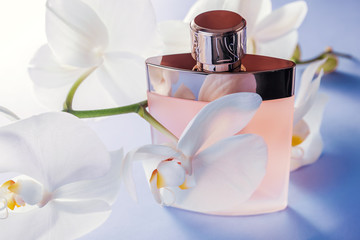 Bottle of perfume with white orchid