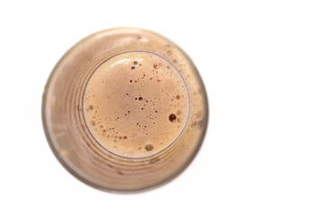 Beautiful bubbles of sweet soda brown in a glass. View from above. Fizzy