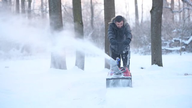 snow blowing man