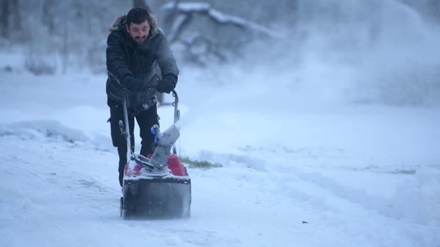 snow blowing man