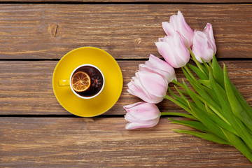 Cup of english tea with spring tulips