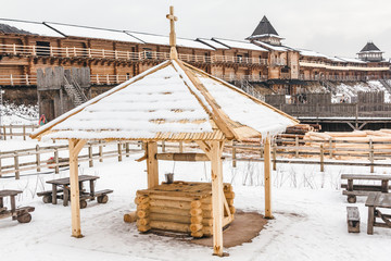 Fototapeta na wymiar An ancient wooden slavic well of handwork. Shrovetide festival in Ancient Kiev