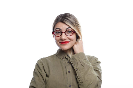 Portrait of cute blonde girl wearing stylish eyeglasses and red lipstick posing in studio in good mood, rejoicing at positive news as she just learnt that her friend is going to get married