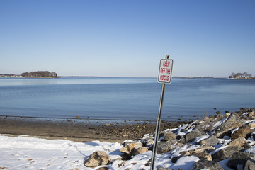 keep off rocks sign on a beach