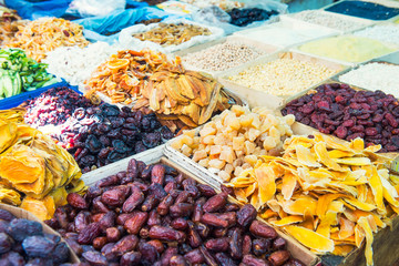 Close up assorted dried fruits and berries on market place in Tel Aviv, Israel. Selective focus,...