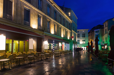 Fototapeta na wymiar Night view of Nimes streets and building illuminated at dusk