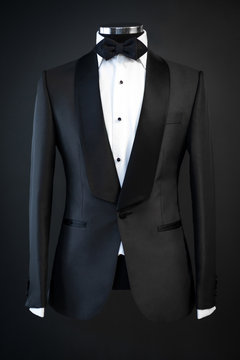 Tailored suit, tuxedo isolated on black background on mannequin