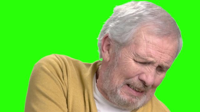 Elderly man having shoulder pain. Senior man suffering from arthritis on chroma key background.