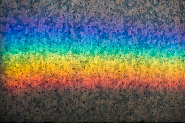Colorful rainbow reflection on a stone backgroud