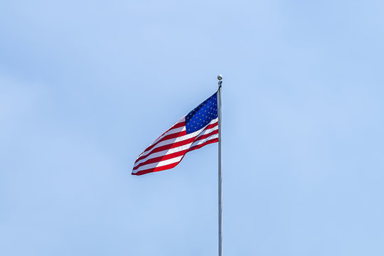 United States of America Flag over a clear blue sky backgound