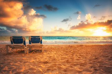 Sunrise, beach chairs on the tropical carribean beach. - obrazy, fototapety, plakaty