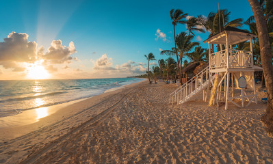 Punta Cana sunrise over Caribbean beach with lifeguard station - obrazy, fototapety, plakaty