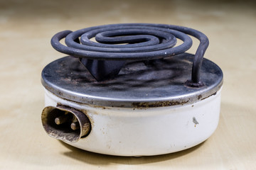 Electric razor for cooking lunch and water for tea. Old kitchen accessories on an old heater.