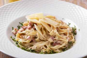 pasta carbonara with parmesan and greens on a plate