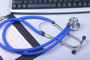 Stethoscope on a modern keyboard, RX prescription on white table with space for text