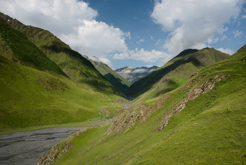 Landscape of a mountain valley with view at mountain river and mountain range.