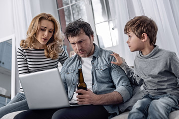 Attentive relatives. Attentive calm man fighting his alcohol addiction and trying to find a new job...