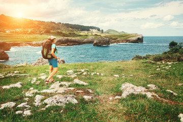 Girl traveler looks on beautiful sea landscape