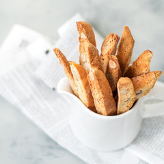 Biscotti (cantuccini) - traditional Italian almond dessert in white cup closeup.