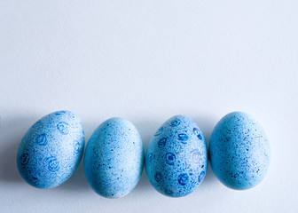 Blue Easter eggs on blue background, top view