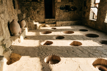 room in the factory for wine, pitchers and special holes in the floor