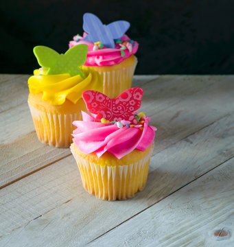 Colorful Spring Cupcakes With Butterflies On Dark Background