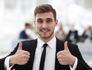 successful businessman showing thumbs up.
