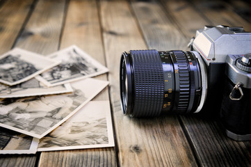 Camera film and vintage prints of aged wooden background.