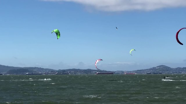 4K HD video of people kite surfing in the San Francisco Bay. Wind is the key element to kiteboarding and it is important to know the direction, speed, and orientation to ensure it is safe to kitesurf.