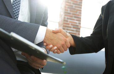 Close-up of two business people shaking hands