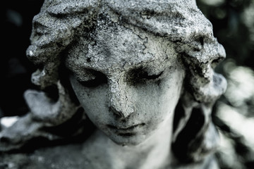 Close up of an ancient statue of guardian angel (vintage style photo)