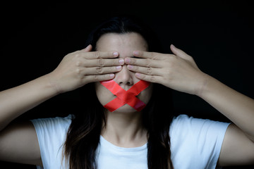 Young woman was wrapping her mount by adhesive tape,  Concept freedom of speech, censorship, freedom of press. International Human Right day.