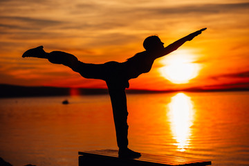Carefree woman meditating in nature.Finding inner peace.Yoga practicing.Spiritual healing lifestyle.Enjoying peace,anti-stress therapy,mindfulness meditation.Positive energy.Dekasana,airplane pose