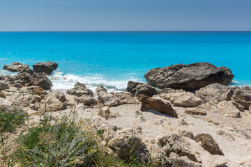 Fototapeta na wymiar Amazing seascape of blue waters of Megali Petra Beach, Lefkada, Ionian Islands, Greece