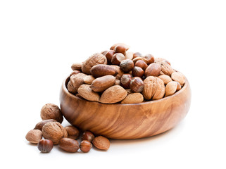 Various  nuts in wooden bowl isolated on white