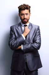 young businessman posing with crossed arms.