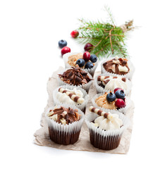 Chocolate  mini cupcakes with christmas decoration isolated on white