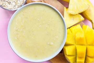 Mango, Banana, Pineapple and Oatmeal Smoothie in the Bowl