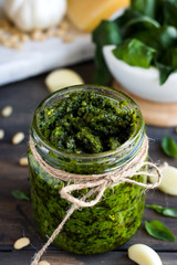 Fresh homemade pesto sauce and ingredients to it